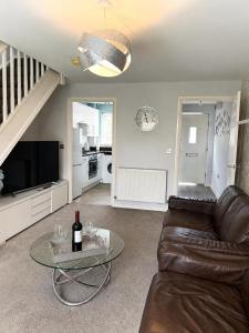 a living room with a couch and a glass table at 2BR House By Cozy Quarters Property Management Contractors Accommodation Spennymoor With Parking in Spennymoor