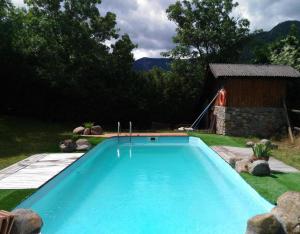 a swimming pool in the middle of a yard at Colònies Cadí - Cal Caló in Bellver de Cerdanya