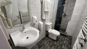 a bathroom with a sink and a toilet at Hotel Rile Men Blue in Niš