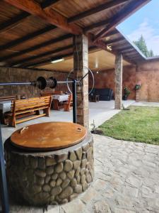 a patio with a wooden table on a stone floor at Stai Ca Acasă in Slănic-Moldova
