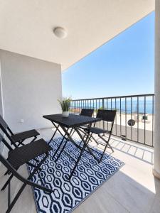 a dining room with a table and chairs on a balcony at Miami in Veliko Brdo