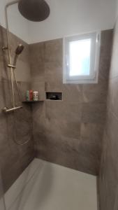 a bathroom with a shower with a window at Pause au coeur des Côtes-Rôtie in Ampuis +8 photos