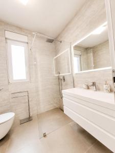 a bathroom with a tub and a sink and a toilet at Miami in Veliko Brdo +12 photos
