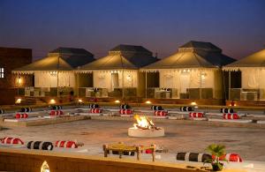 a group of buildings with a fire in front of it at Desert Luxury Camp & Resort Jaisalmer in Jaisalmer +18 photos
