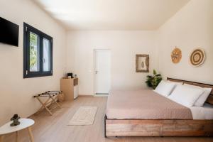a bedroom with a bed in a room at Ornos Collection - by Hospirit in Ornos