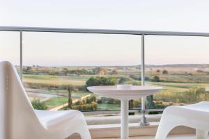 a white table and chairs on a balcony with a view at Laguna - Vilamoura in Vilamoura