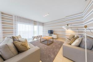 a living room with a couch and a table at Laguna - Vilamoura in Vilamoura