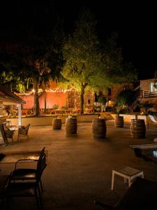 a park with benches and trees at night at Logis Hotel Le Relais du Quercy in Meyssac