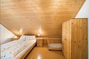 a bedroom with a bed and a wooden ceiling at Jäckleshof in Sankt Georgen im Schwarzwald