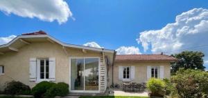 a house with a blue sky and clouds at House with large garden Audenge in Audenge