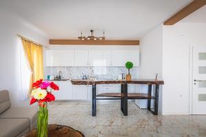a kitchen with a table in the middle of a room at Villa Enigma in Gevgelija +43 photos