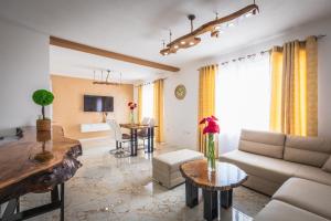 a living room with a couch and a table at Villa Enigma in Gevgelija