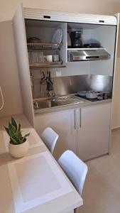a kitchen with a sink and a table and chairs at Stone house 2 in Líthion