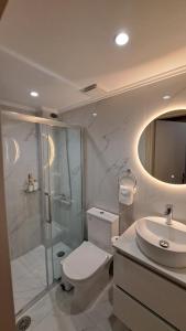 a bathroom with a shower and a toilet and a sink at Stone house 2 in Líthion