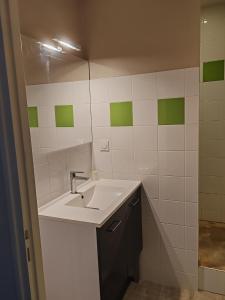 a bathroom with a sink and a mirror at Hotel O'Fun Art in Airvault