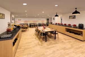 a restaurant with tables and chairs in a room at Ginger Ahmedabad RTO Circle in Ahmedabad +23 photos