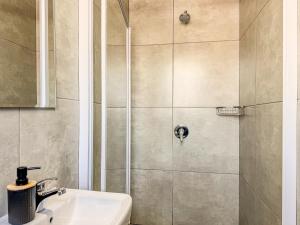a bathroom with a shower with a sink at Cosmo Sleepover in Roodepoort +37 photos