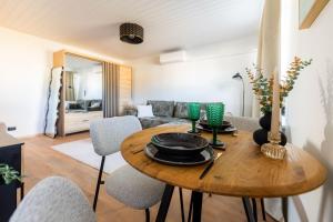 a living room with a wooden table and chairs at Marie` Apartment in Salme