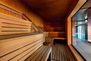 an empty sauna with wooden walls and wooden floors at Polanica Park, Sun&Snow in Polanica-Zdrój