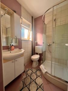 a bathroom with a sink and a toilet and a shower at Apartments Kristal in Kaštela +58 photos