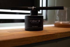 a bottle of london vim sitting on a wooden table at Industrial Design Studios - Lohnhalle Essen in Essen +26 photos