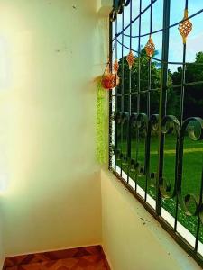 a window with a view of a green field at MERED Haven Studio in Kilifi