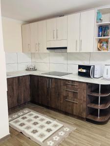 a kitchen with wooden cabinets and a white counter top at Nice House in Slavske