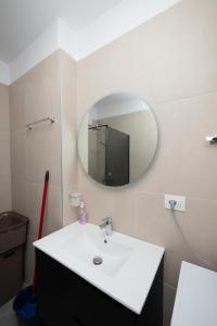 a bathroom with a sink and a mirror on the wall at Golem Escape in Kavajë +16 photos