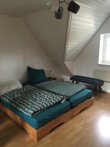 a bedroom with a bed in a attic at Im Grünen in Klein Trebbow