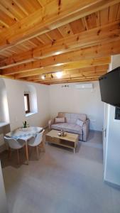 a living room with a couch and a table at Stone house 1 in Líthion