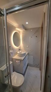 a bathroom with a toilet and a sink at Stone house 1 in Líthion +15 photos