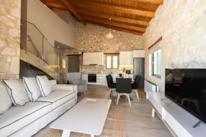 a living room with a couch and a table at Τilevoides Nisi Villas in Spartokhórion