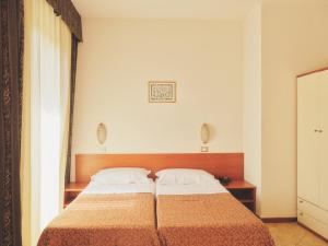 a bedroom with a large bed in a room at Hotel Palazzo dei Priori in Siena +8 photos