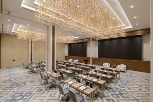 a dining room with tables and chairs and a stage at Doubletree By Hilton Tashkent in Tashkent +221 photos