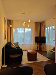 a living room with a couch and a tv at Studios zur Schmiede in Weyregg