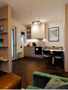 a kitchen and living room with a table and chairs at Studios zur Schmiede in Weyregg