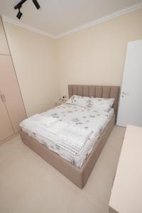 a bedroom with a bed in a white room at Golem Escape in Kavajë