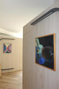 a room with two paintings on the wall at LEON D'ORO - Art Hotel in Pieve di Soligo