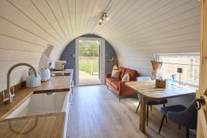 a kitchen and living room in a tiny house at Waters Edge Cabin in Helmsley