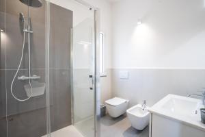 a bathroom with a shower and a toilet and a sink at GiuMar Apartments Acitrezza in Aci Catena +37 photos