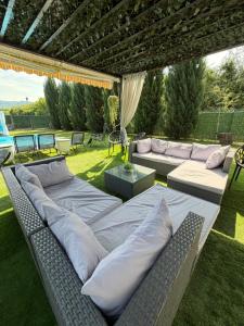 a patio with pillows and a couch on the grass at Casa Fred in Sîmbotin