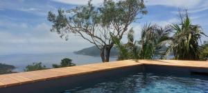 a swimming pool with a view of the ocean at CAP AZUR ILE du LEVANT in Île du Levant