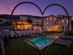 a home with a heart shaped pool in the yard at Dolce Bacio in Valdobbiadene