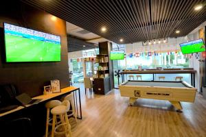 a room with a pool table and a tv at Kokotel Bangkok Dheva Thonglor in Bangkok