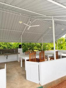 a tent with a table and chairs under it at Green Techno Villa in Kitulkote