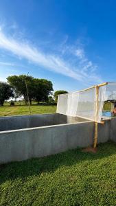 a water fountain in a field with trees in the background at Green Techno Villa in Kitulkote