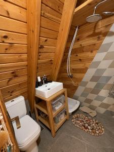 a bathroom with a sink and a toilet and a shower at M Place in Shārūn +30 photos