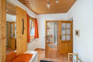 a living room with a couch and a wooden ceiling at Jäckleshof in Sankt Georgen im Schwarzwald +92 photos