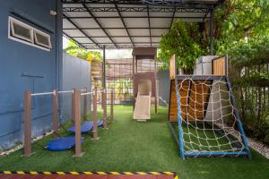 a childrens playground with a batting cage and a play set at Kokotel Bangkok Dheva Thonglor in Bangkok +78 photos