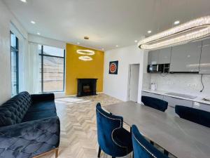 a kitchen and a dining room with a table and chairs at Royal Villa in Yoliin Hural